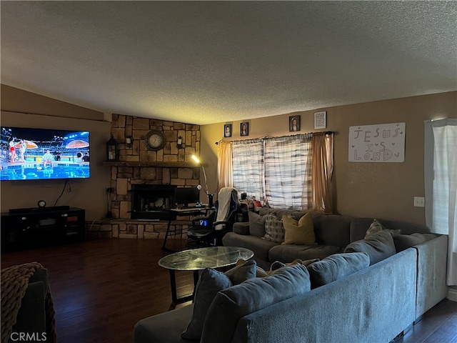 living room with a stone fireplace, hardwood / wood-style floors, a textured ceiling, and vaulted ceiling