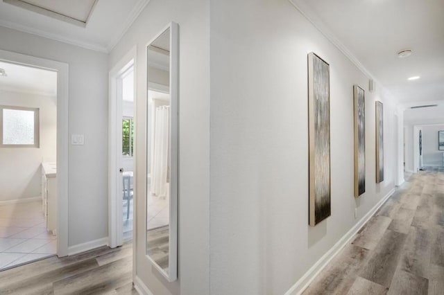 hall featuring ornamental molding and light hardwood / wood-style floors