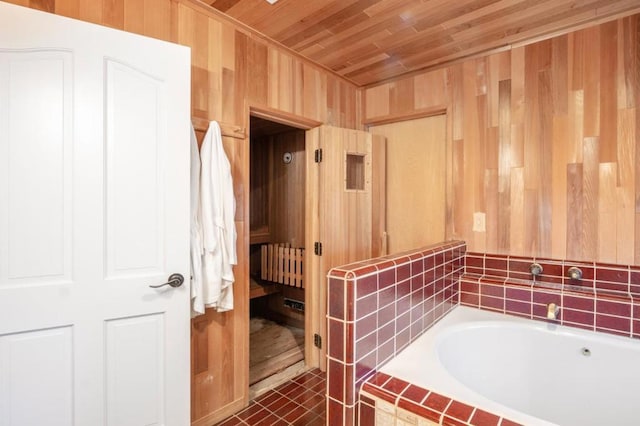 bathroom with tiled tub, radiator heating unit, wood ceiling, and wood walls