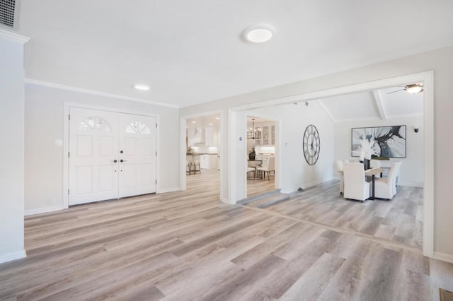 entryway with vaulted ceiling with beams and light hardwood / wood-style floors