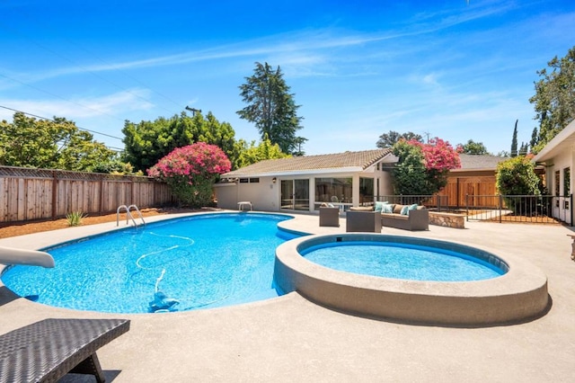 view of pool with an in ground hot tub, an outdoor hangout area, and a patio area