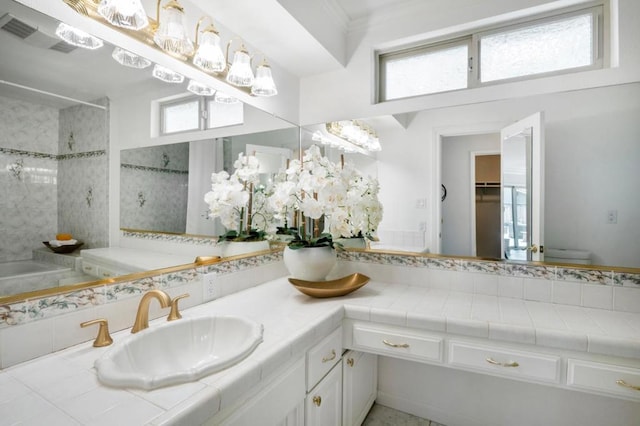 bathroom featuring vanity, a tile shower, crown molding, and toilet