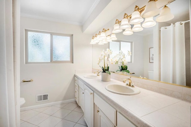 bathroom with ornamental molding, toilet, and a wealth of natural light