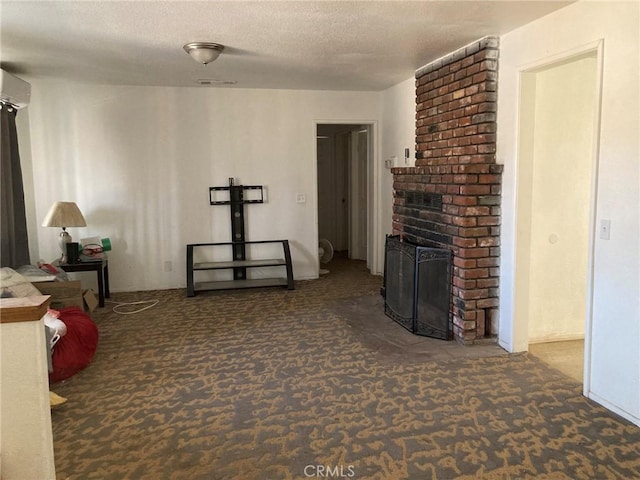 carpeted living room featuring an AC wall unit, a textured ceiling, and a brick fireplace