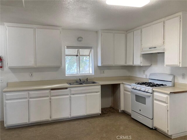 kitchen featuring a textured ceiling, white cabinetry, gas range gas stove, and sink