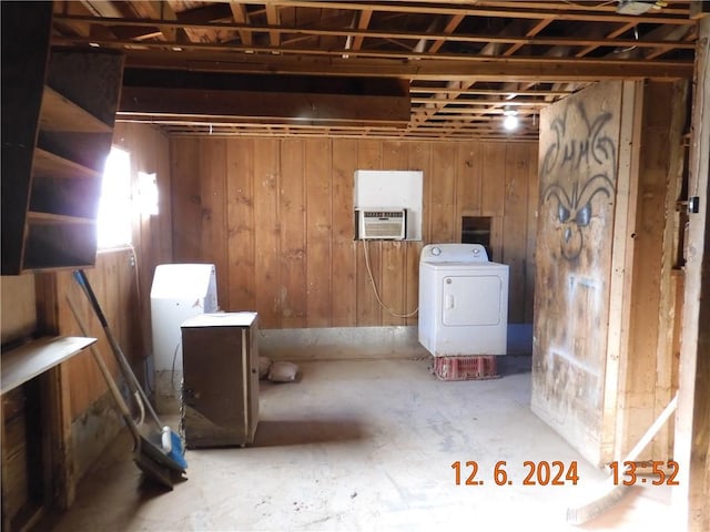 basement with washer / dryer and wooden walls