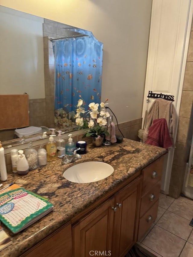 bathroom featuring tile patterned flooring and vanity