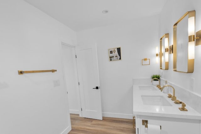 bathroom with hardwood / wood-style floors and vanity