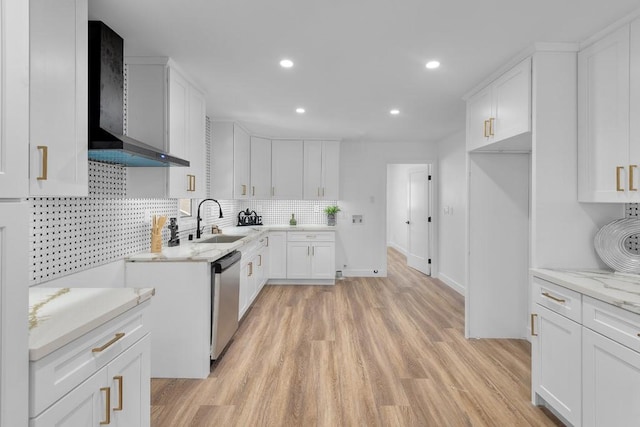 kitchen with dishwasher, wall chimney range hood, sink, light hardwood / wood-style flooring, and white cabinetry