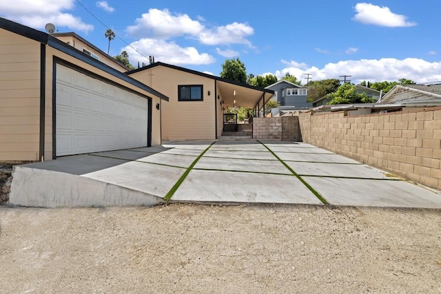 view of front of house with a garage and a carport