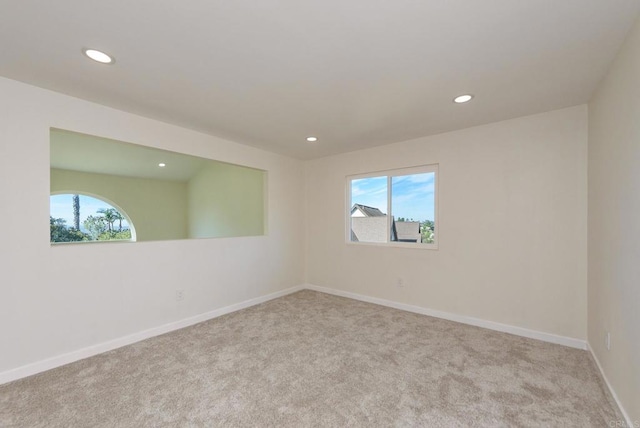 carpeted spare room featuring a healthy amount of sunlight