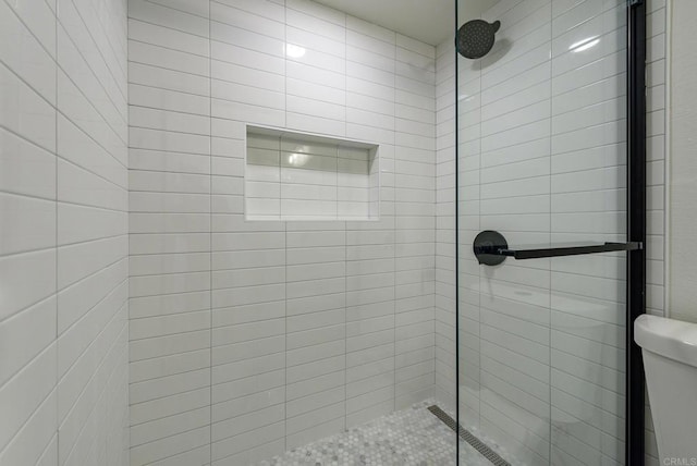 bathroom with toilet and walk in shower