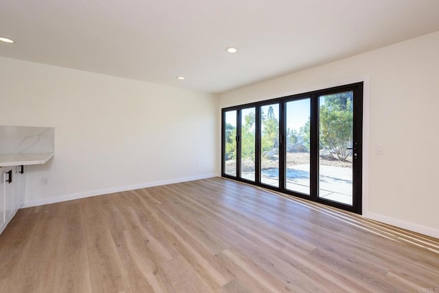 unfurnished room with light hardwood / wood-style floors