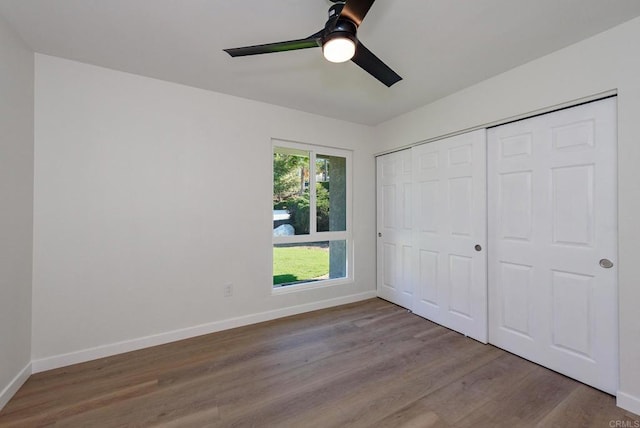 unfurnished bedroom featuring a closet, ceiling fan, and light wood-type flooring