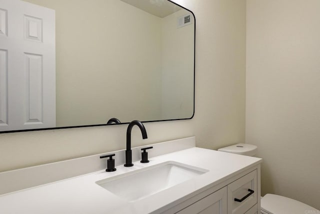 bathroom with toilet and vanity