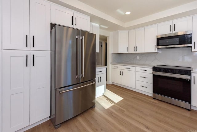 kitchen featuring white cabinetry, light hardwood / wood-style floors, and appliances with stainless steel finishes