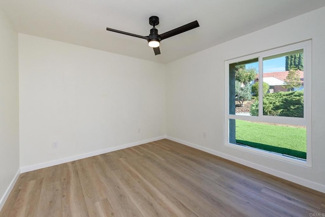 empty room with light hardwood / wood-style floors and ceiling fan