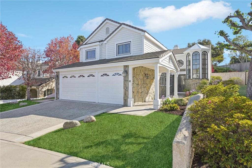 front of property featuring a front yard and a garage