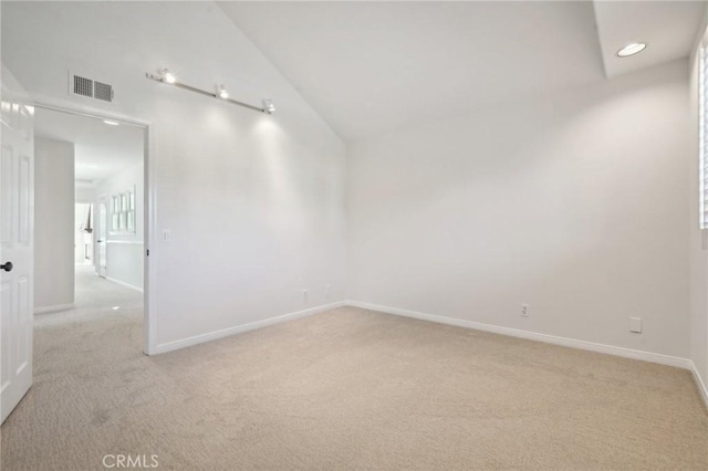 carpeted empty room with lofted ceiling