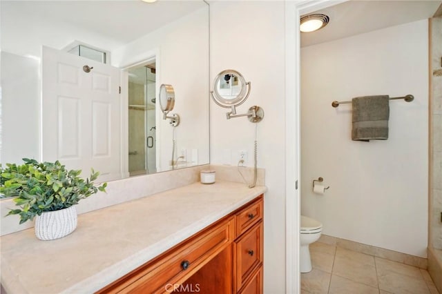 bathroom with toilet, vanity, walk in shower, and tile patterned flooring