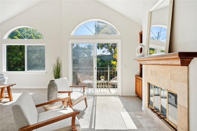 sunroom / solarium featuring a fireplace, plenty of natural light, and vaulted ceiling