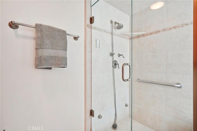 bathroom with a shower with shower door