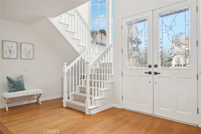 foyer featuring wood-type flooring and french doors