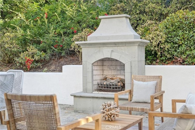 view of patio with an outdoor fireplace