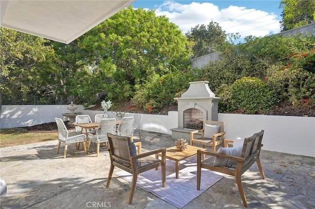 view of patio featuring an outdoor fireplace