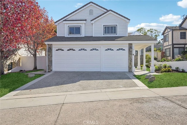 front of property featuring a front lawn and a garage