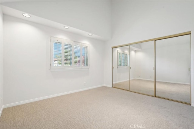 unfurnished bedroom featuring a closet and carpet flooring