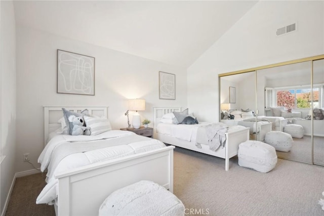 bedroom featuring high vaulted ceiling, dark carpet, and a closet