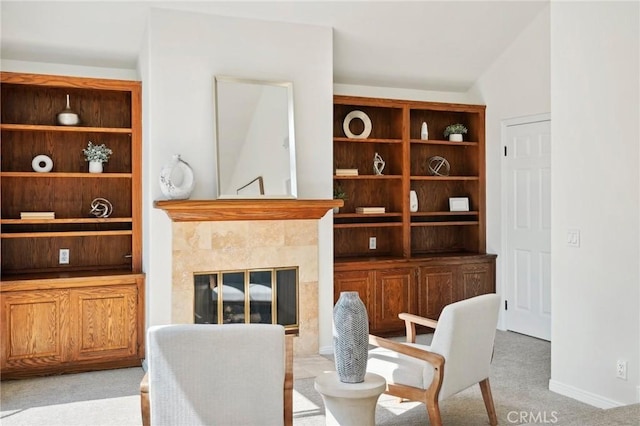 carpeted dining space with vaulted ceiling and a fireplace