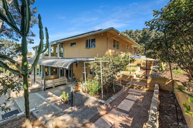 back of house with a patio area and a sunroom