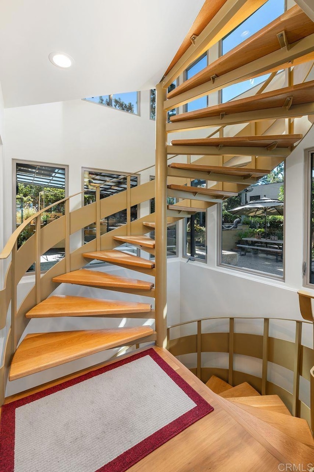 stairway featuring vaulted ceiling