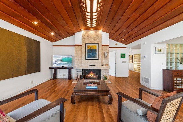 living room featuring wooden ceiling, a large fireplace, lofted ceiling, and hardwood / wood-style floors