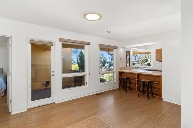 interior space featuring decorative backsplash and light hardwood / wood-style flooring