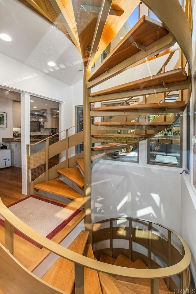 stairway with hardwood / wood-style floors