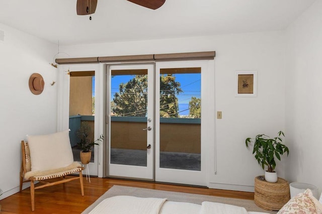 doorway to outside featuring ceiling fan and wood-type flooring