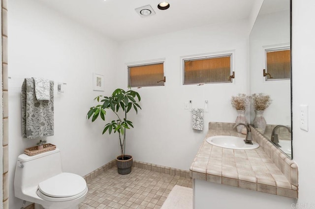 bathroom featuring toilet, tile patterned flooring, and vanity