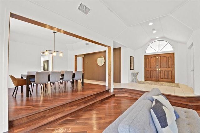 entrance foyer featuring wood-type flooring and vaulted ceiling