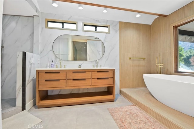 bathroom featuring vanity and a washtub