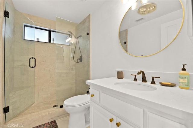 bathroom with tile patterned floors, vanity, toilet, and a shower with shower door