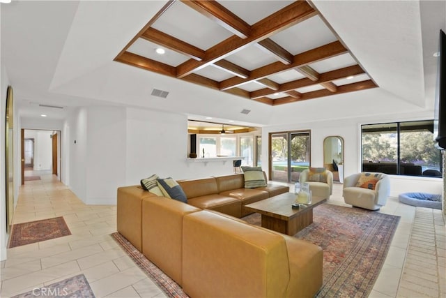 living room with light tile patterned floors, plenty of natural light, and coffered ceiling