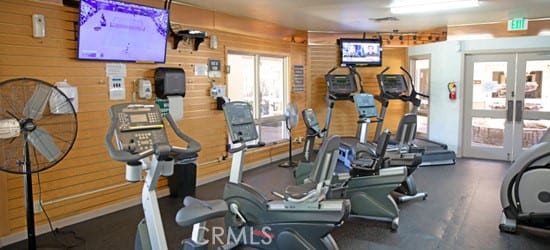 workout area featuring wooden walls and french doors