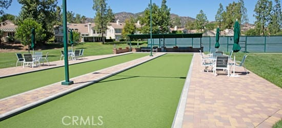 surrounding community with a lawn and a mountain view