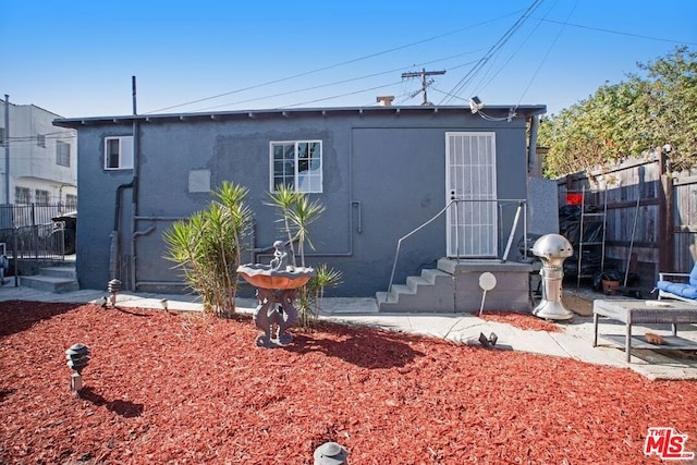 rear view of property featuring a patio area