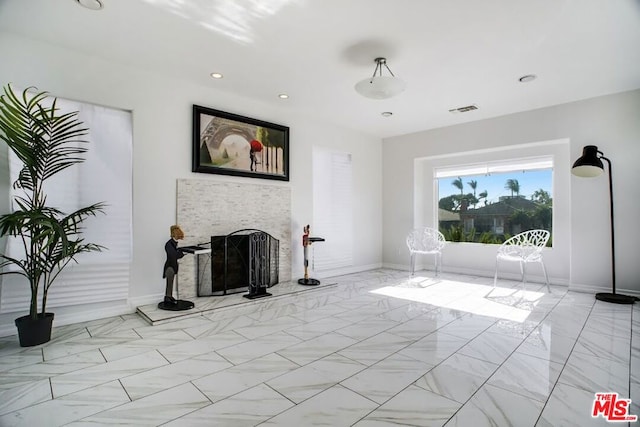 living room with a stone fireplace