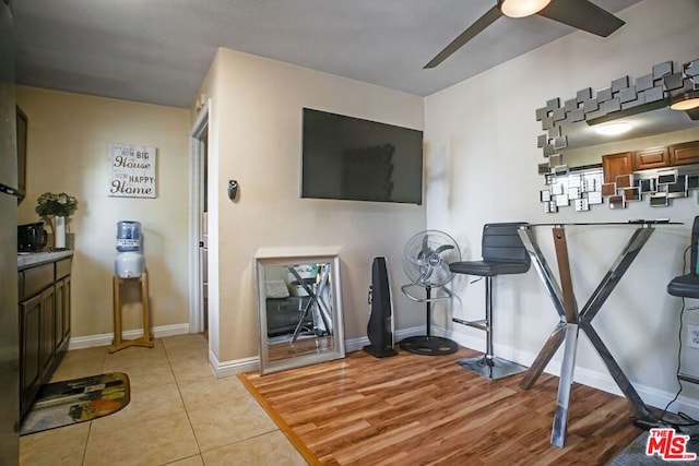 living room with light hardwood / wood-style floors and ceiling fan