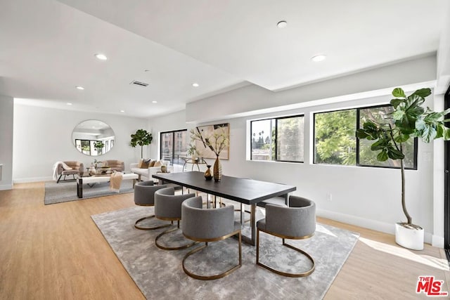 dining space with light hardwood / wood-style flooring